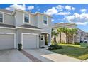 Exterior view of townhouse featuring well-maintained landscaping, sidewalks, and a neatly kept lawn at 34196 Polacca Ln, Wesley Chapel, FL 33543