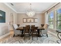 Formal dining room featuring a decorative chandelier, neutral walls, and ample natural light at 4012 W Obispo St, Tampa, FL 33629