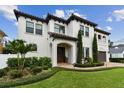 Beautiful two-story home featuring manicured landscaping, a barrel tile roof, and a brick paver driveway at 4012 W Obispo St, Tampa, FL 33629