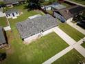 Aerial view of a single-story home, showcasing the lush lawn and spacious driveway at 5018 Pine St, Seffner, FL 33584