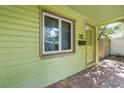 Welcoming front porch featuring a stylish door, a window, and a charming, vintage-inspired design at 5135 21St Avenue N, St Petersburg, FL 33710