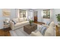 Bright living room with neutral furniture, stylish rug, wood floors, and natural light from windows at 5135 21St Avenue N, St Petersburg, FL 33710