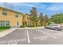 Attractive townhome complex with reserved parking, mature trees, and meticulously maintained landscaping at 6332 Timberly Ln, Zephyrhills, FL 33542