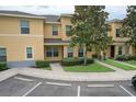 Charming townhome with lush landscaping, a welcoming entrance, and convenient parking spaces at 6332 Timberly Ln, Zephyrhills, FL 33542