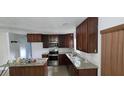 Kitchen with granite countertops, stainless steel appliances and dark wood cabinets at 10918 N Boulevard, Tampa, FL 33612