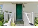 Inviting front entrance with a vibrant green door, white railing, and decorative details at 1222 Palm St, Clearwater, FL 33755