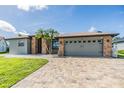 Attractive single-story house with brick accents, a two-car garage, and paved driveway at 12910 Prestwick Dr, Riverview, FL 33579