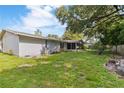 Spacious backyard with a mix of grass and patio, perfect for outdoor enjoyment at 16113 Tampa St, Lutz, FL 33548