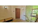 Condo entrance with private stairwell and exterior bench near the front door at 16501 Harper Pond Ln # 308, Odessa, FL 33556