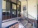 Inviting entrance with a screened-in porch and concrete steps with metal railing leading to the front door at 1710 7Th Sw St # 39, Ruskin, FL 33570