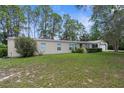 Well-maintained single-story home featuring a green lawn and simple landscaping at 17207 Bosley Dr, Spring Hill, FL 34610