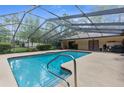 Screened-in pool featuring a relaxing recreational space for swimming and lounging at 17207 Bosley Dr, Spring Hill, FL 34610