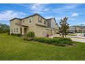 Charming two-story home featuring manicured landscaping and a well-maintained lawn under a bright sky at 17741 Tawny Malt Pl, Land O Lakes, FL 34638