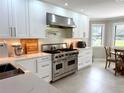 Bright kitchen features white cabinets, stainless steel appliances, and quartz countertops at 17926 Calkins Ct, Spring Hill, FL 34610