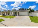 Charming one-story home with a well-manicured lawn, a two-car garage and appealing landscaping at 1803 E Powhatan Ave, Tampa, FL 33610