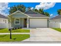 Charming one-story home with a well-manicured lawn, a two-car garage and appealing landscaping at 1803 E Powhatan Ave, Tampa, FL 33610
