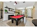 Spacious game room featuring a pool table, stylish shelving, and an open view of the front entry at 2009 Raven Manor Dr, Dover, FL 33527
