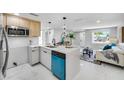 Bright kitchen features sleek cabinetry, modern appliances, and a convenient island with bar seating at 208 Palmetto W Rd, Nokomis, FL 34275