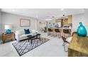 Open-concept living room filled with light, flowing into kitchen with breakfast bar for flexible living at 208 Palmetto W Rd, Nokomis, FL 34275