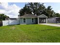Charming single-story home featuring a well-maintained lawn and a screened front porch at 2304 W Rio Vista Ave, Tampa, FL 33603