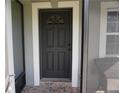 The covered front porch leads to a solid dark front door, framed with white trim at 2304 W Rio Vista Ave, Tampa, FL 33603