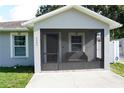 Inviting screened front porch with seating and tiled floor at 2304 W Rio Vista Ave, Tampa, FL 33603