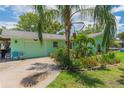 Charming one-story home with a lushly landscaped yard and driveway at 33 Cypress Dr, Palm Harbor, FL 34684
