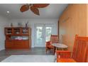Living room featuring hard wood floors, wooden chairs, built in cabinet, and glass door to outside at 33 Cypress Dr, Palm Harbor, FL 34684