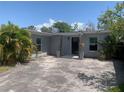Charming single-story home with a paved driveway and covered entrance at 3927 Huntington Ne St, St Petersburg, FL 33703