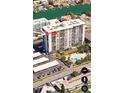 Aerial view of a condo building with a pool and parking area at 400 Island Way # 1606, Clearwater Beach, FL 33767