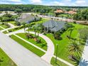 Beautiful home with circular drive, mature landscaping, and tranquil water views in a quiet neighborhood at 4521 Cheval Blvd, Lutz, FL 33558