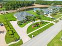 Attractive home showcases well-manicured lawn, mature palm trees, and paved driveway leading to the entrance at 4521 Cheval Blvd, Lutz, FL 33558