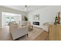 Comfortable living room with modern decor, electric fireplace, recessed lighting, and a view of the pool at 4611 W Bay Court Avenue, Tampa, FL 33611