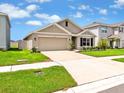 Attractive single-Gathering home featuring a well-maintained lawn and spacious two-car garage at 5474 Flint Hills Dr, Wimauma, FL 33598