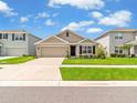 A single-story home with a two-car garage, manicured lawn, and inviting curb appeal at 5474 Flint Hills Dr, Wimauma, FL 33598