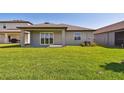A covered patio and bright green lawn make the backyard an ideal space for relaxation at 8077 Tea Olive Ter, Palmetto, FL 34221
