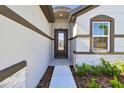 Inviting front entrance with a stylish door and stone accents, perfect for welcoming guests at 8077 Tea Olive Ter, Palmetto, FL 34221