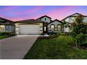 Charming single-Gathering home showcases lush landscaping and a convenient two-car garage at 8077 Tea Olive Ter, Palmetto, FL 34221