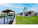 Waterfront property featuring a boat lift, tiki bar, and lush landscaping for relaxing by the canal at 108 W Saint Johns Way # 210, Apollo Beach, FL 33572