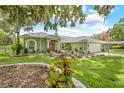 Charming home with a green exterior, manicured lawn, and inviting front yard at 1271 Candlelight Blvd, Brooksville, FL 34601