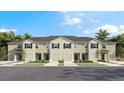 Charming townhomes featuring individual garages and light exteriors perfect for modern living at 17469 Spanish Oak Loop, Land O Lakes, FL 34638