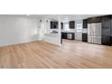 Bright, open-concept living and kitchen space with light wood floors at 209 Se Jefferson N Cir, St Petersburg, FL 33702