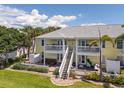 Inviting two-story townhouse featuring a private patio and white exterior staircase at 225 Pompano Se Dr # D, St Petersburg, FL 33705
