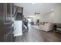 Welcoming living room with hardwood floors, a cozy sofa, and an open floor plan at 2469 Stapleford Pl, Wesley Chapel, FL 33543