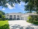 Single story home with 3 car garage, well-kept landscaping, and a large driveway at 3612 Cordgrass Dr, Valrico, FL 33596