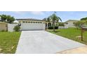 Single-story home with a large driveway and well-kept lawn at 3633 Odom Dr, New Port Richey, FL 34652