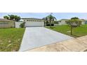 Single-story home with a large driveway and well-kept lawn at 3633 Odom Dr, New Port Richey, FL 34652
