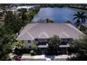 Scenic aerial view of the townhouse complex and the surrounding lake with lush vegetation at 3909 45Th W Ter # 102, Bradenton, FL 34210