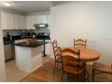 Eat-in kitchen features white cabinetry, black countertops, and stainless-steel appliances at 501 Knights Run Ave # 2218, Tampa, FL 33602