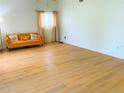 Bright living room with hardwood floors, neutral walls and natural light at 5154 Balsam Dr, Land O Lakes, FL 34639
